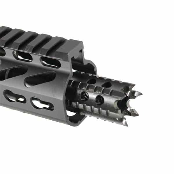 Close-up of black AR-15 muzzle brake with oval ports and pronged tip for tactical use.