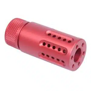 Red anodized AR-15 muzzle brake with knurled grip and perforations for recoil reduction.