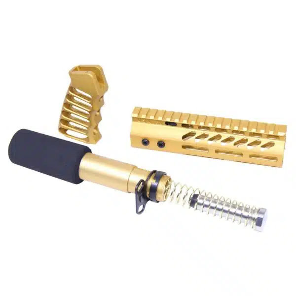 Gold anodized AR-15 parts including grip, handguard, buffer tube, and spring on white background.