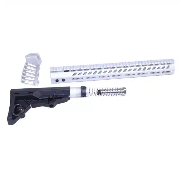 Disassembled AR-15 parts: grip, recoil spring, and aluminum handguard for customization.