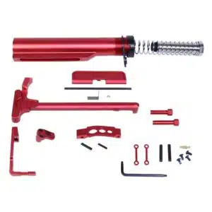 Red anodized AR-15 parts kit: buffer tube, charging handle, trigger guard, tools included.