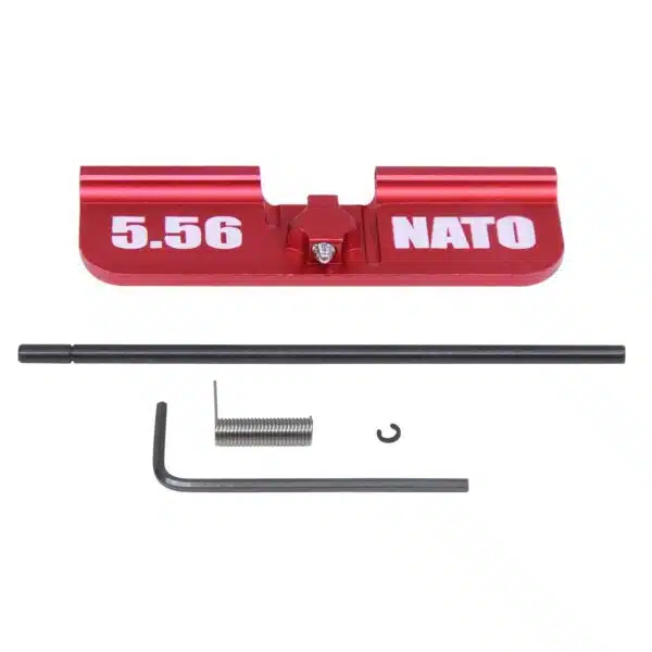Red anodized AR-15 dust cover kit with 5.56 NATO marking and installation components.