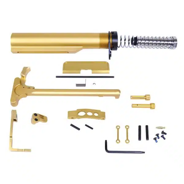 Gold-anodized AR-15 parts kit with buffer tube, charging handle, and assembly tools.