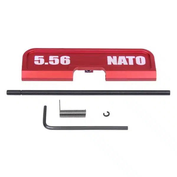 Red anodized AR-15 dust cover with 5.56 NATO text; customization parts included.