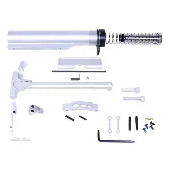 AR-15 parts kit: buffer tube, tools, and components for rifle assembly on white background.