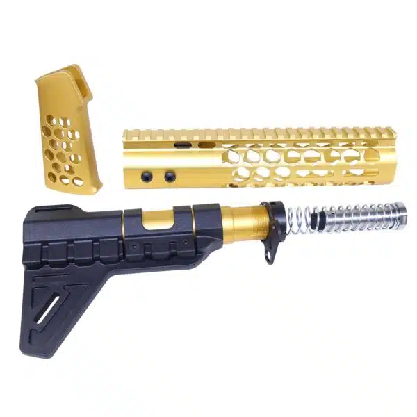Custom AR-15 parts in black and gold, featuring perforated design for weight reduction.