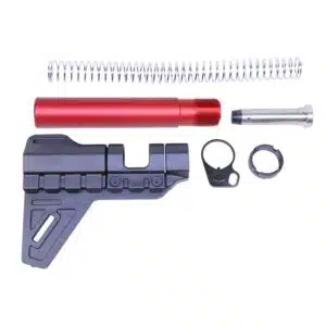 Disassembled AR-15 pistol brace kit with red buffer tube, black brace, spring, hardware.