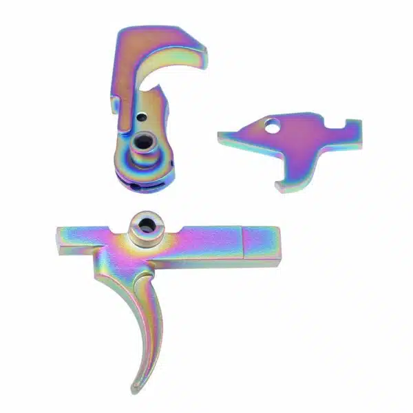 Iridescent AR-15 trigger parts with rainbow PVD finish on white background.