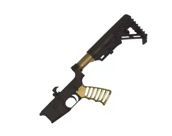 Two-tone tactical firearm receiver with black upper, gold grip, and accessory rails.