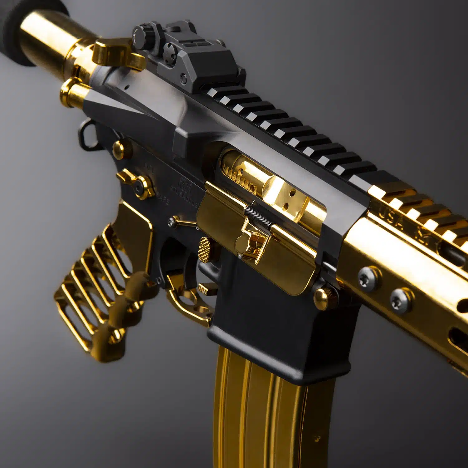 Gold plated AR-15 forward assist assembly installed on a black upper receiver