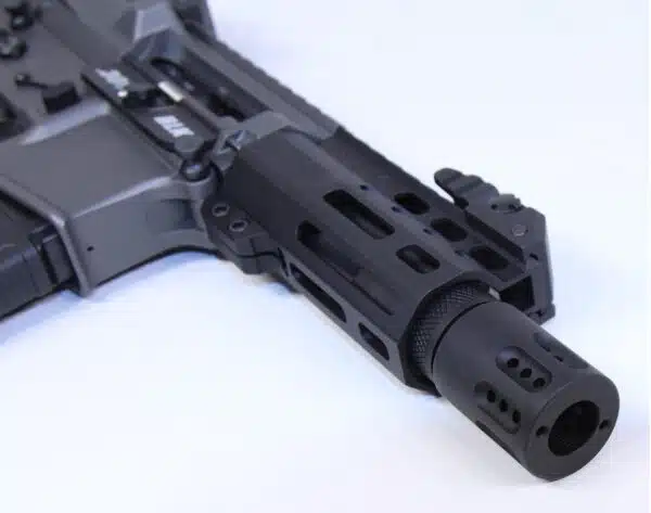 Modern black AR-platform firearm showcasing muzzle brake and ventilated handguard.