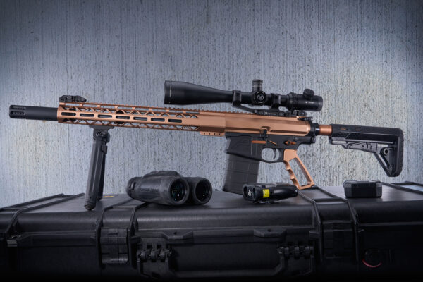 Anodized bronze .308 cal rifle with scope and accessories in a hard-shell case.