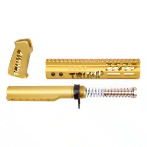 Gold AR-15 components with TRUMP engravings, featuring pistol grip, handguard, and buffer tube.