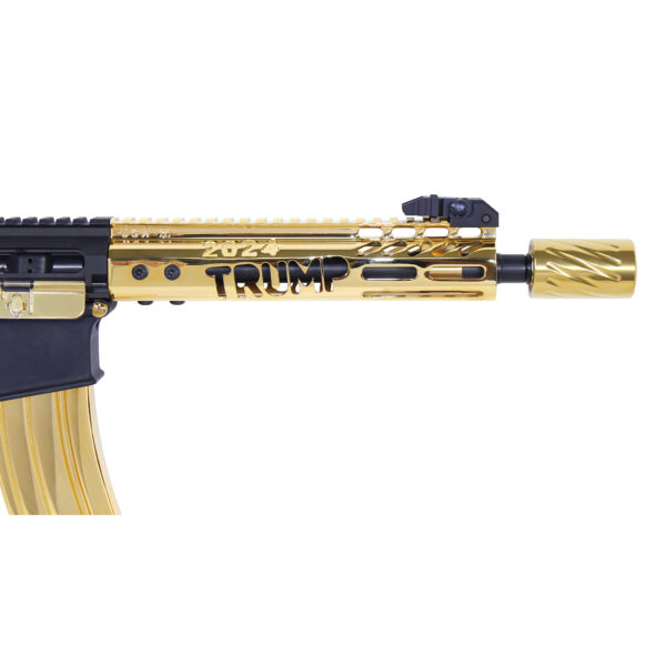 Gold-plated AR rifle with TRUMP engraving, contrasting black and gold parts on white background.